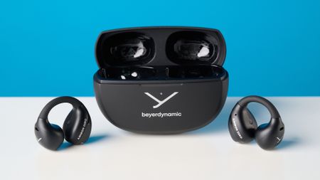 Beyerdynamic Amiron ZERO open-earbuds photographed on a blue background