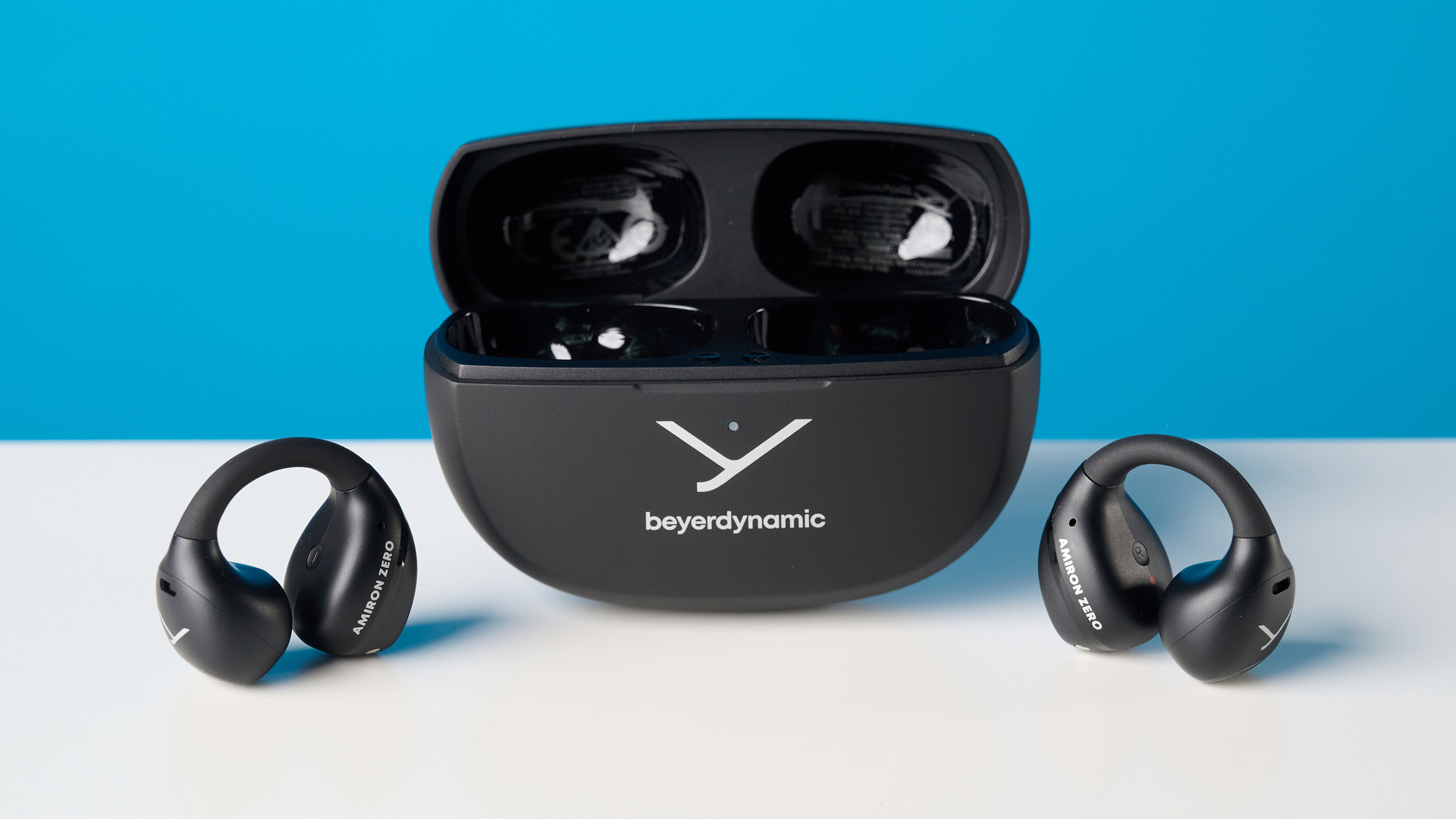 Beyerdynamic Amiron ZERO open-earbuds photographed on a blue background