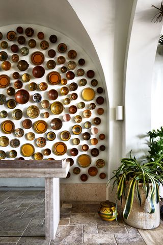 Warm coloured bowls display on white wall
