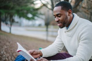 A man reading a book in an effort to be a lifelong learning