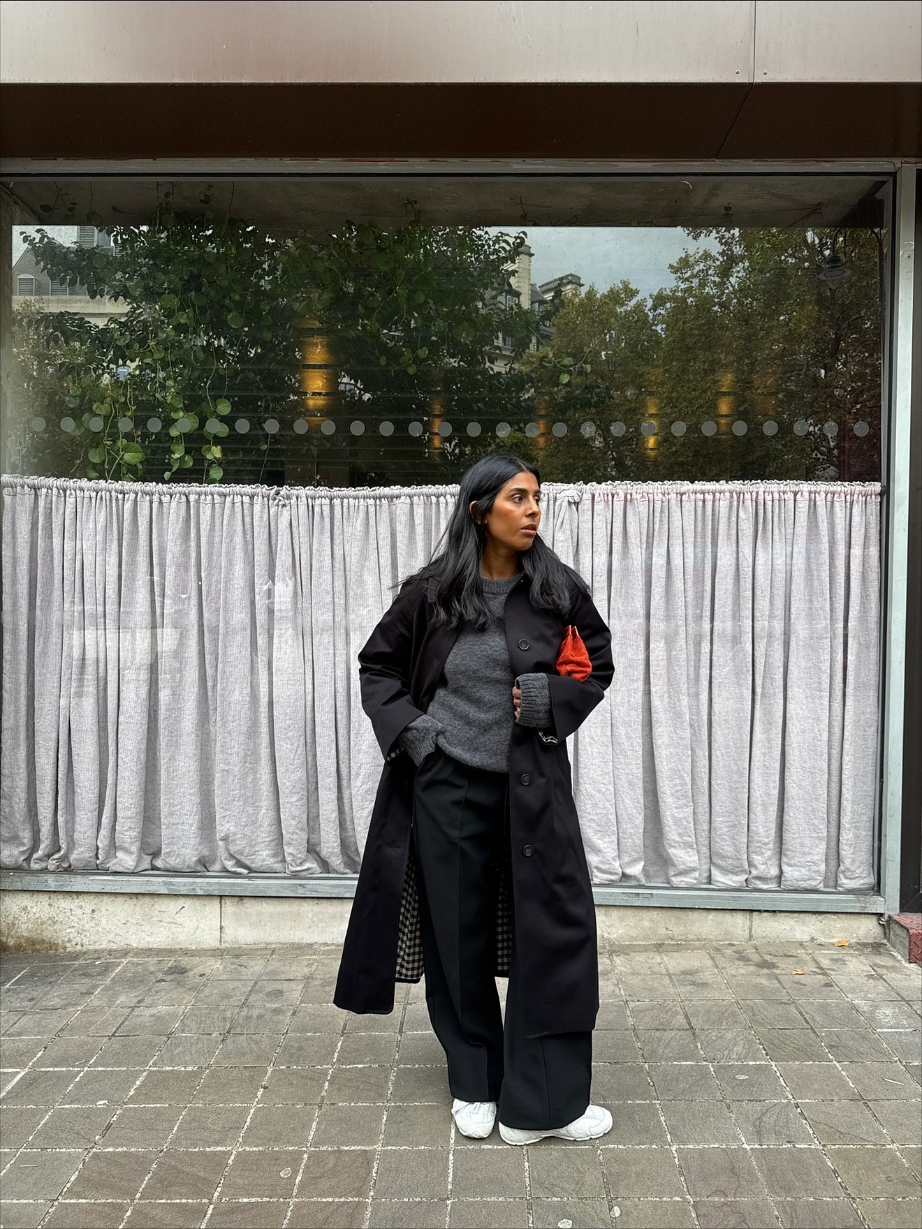 An influencer wearing a black trousers outfit.