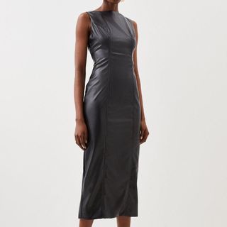 Model wearing high neck midi dress in faux black leather