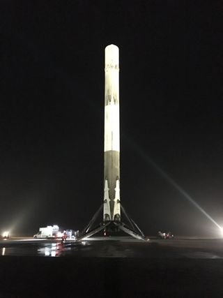 The first stage of SpaceX's Falcon 9 rocket stands triumphantly on Landing Site 1 at Cape Canaveral Air Force Station in Florida after successfully launching into orbit and returning to Earth on Dec. 21, 2015.