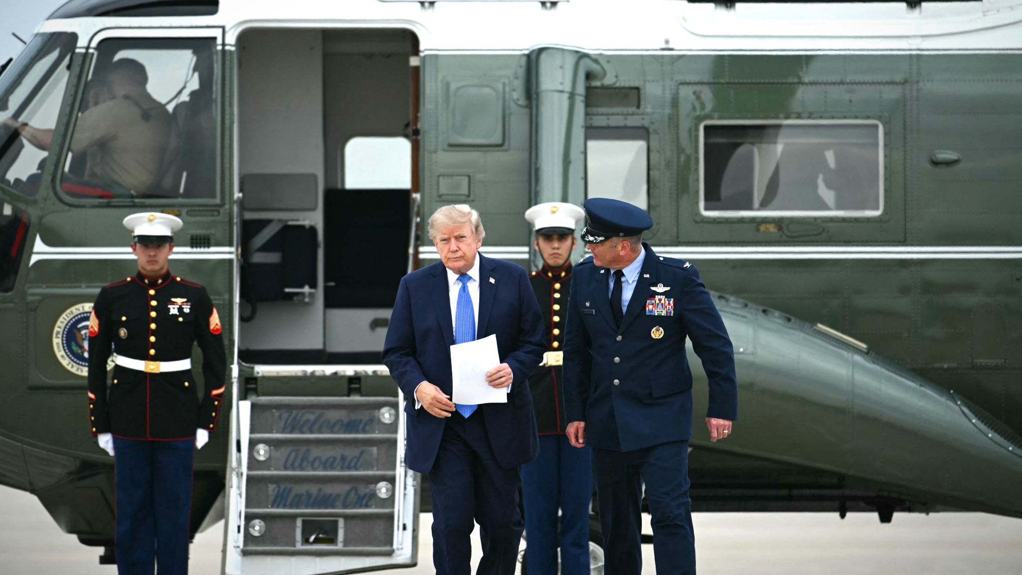 President Donald Trump steps off Marine One as he walks to board Air Force One at Joint Base Andrews, Maryland