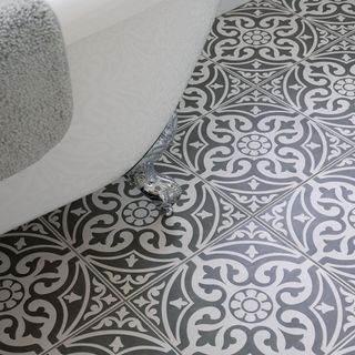 bathroom with white and black designed flooring