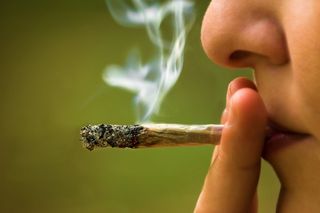 A woman smokes marijuana