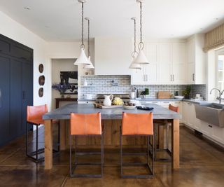 Modern farmhouse kitchen with a large kitchen island topped with a soapstone countertop