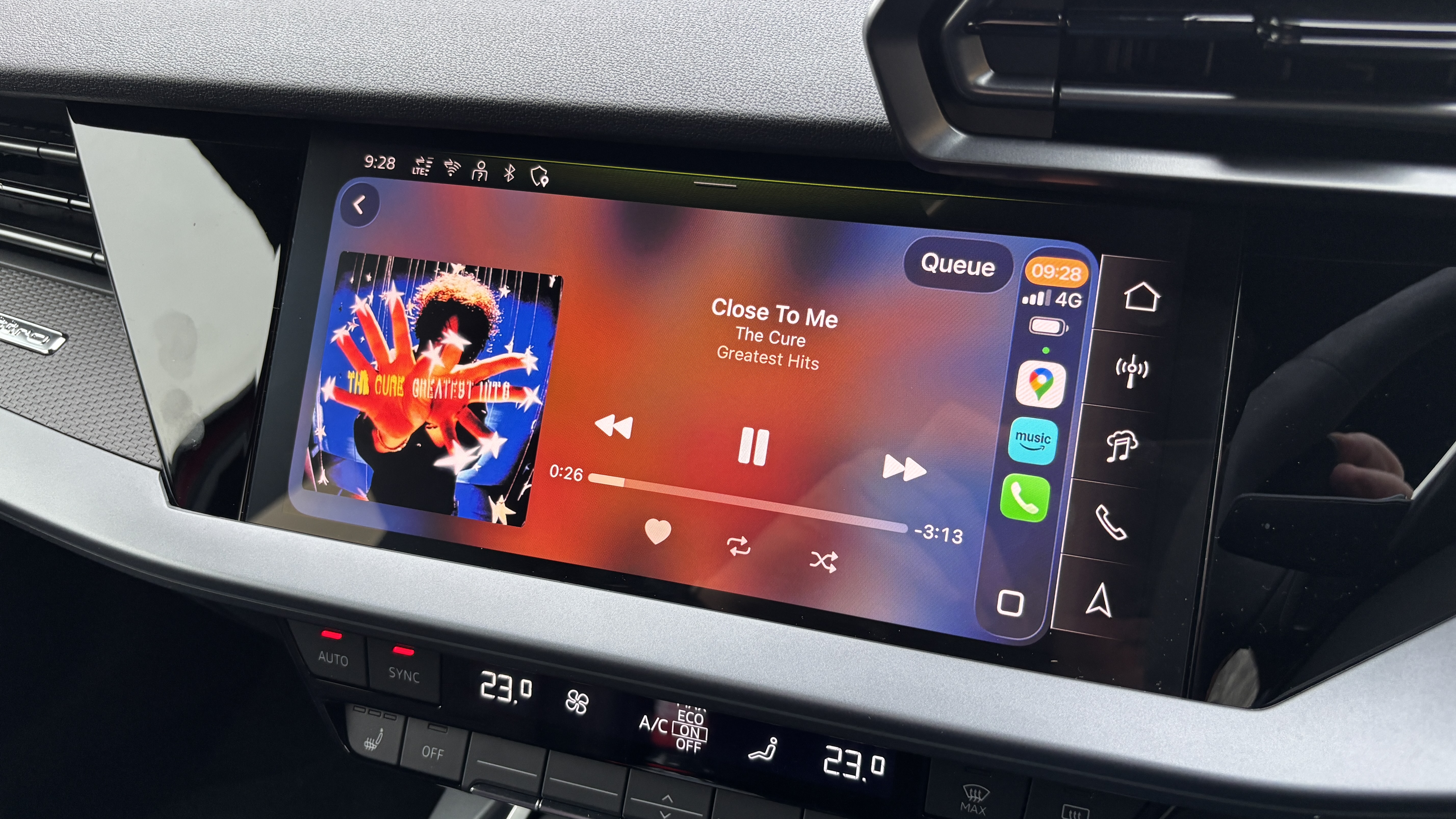 Audi A3 MMI touchscreen interface with CarPlay and album artwork on it