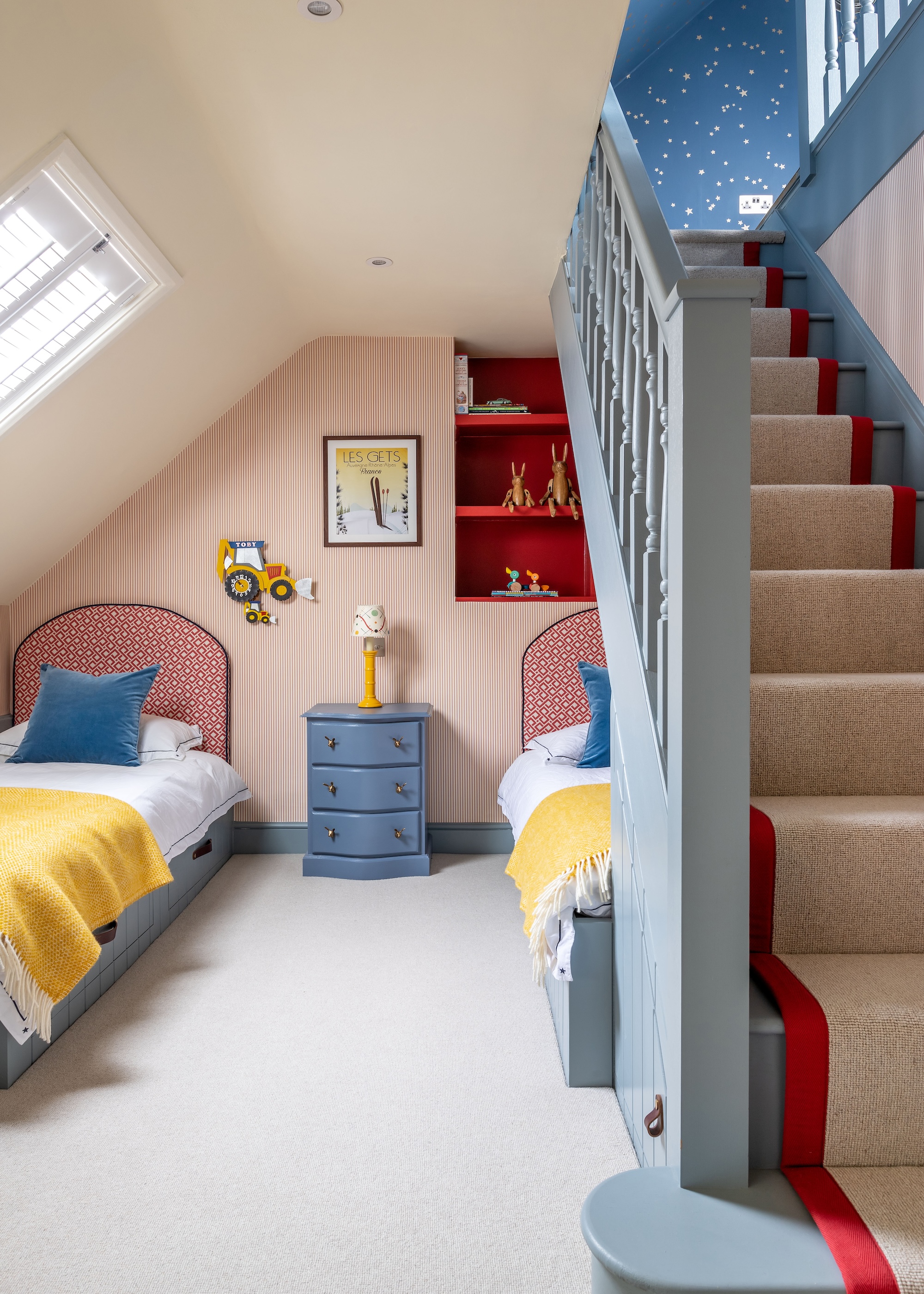 a split level loft conversion showing a children's bedroom on the lower zone with stairs leading up to a playroom on the higher floor