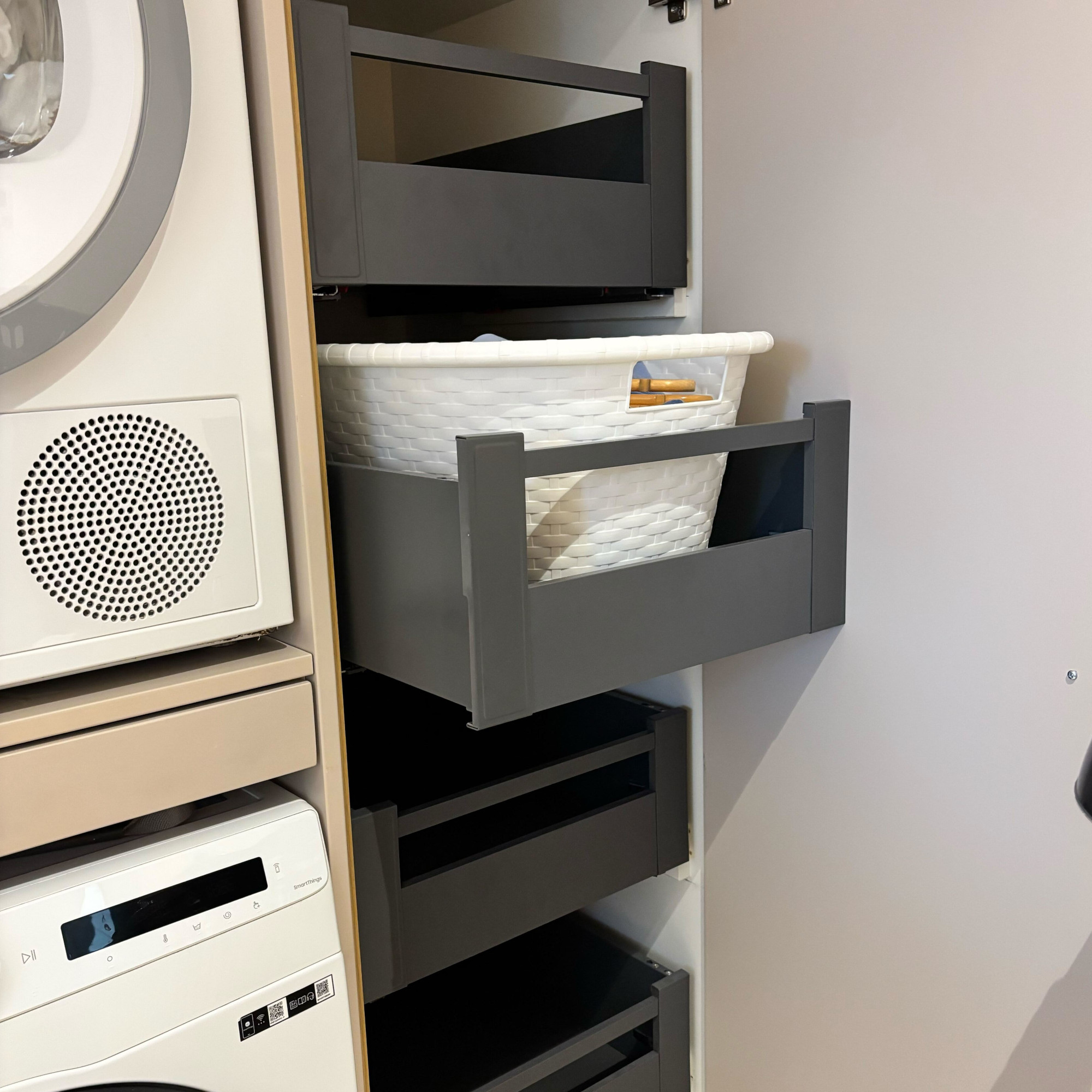 baskets in pull out drawers in a utility room