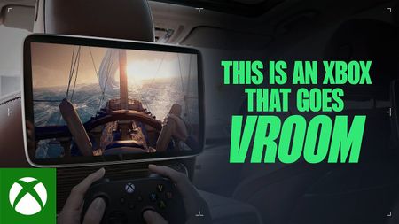 this is an xbox that goes vroom showing someone playing xbox games on a screen in a car