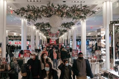 holiday shoppers make a last-minute trip to the Macy's flagship department store in Midtown, Manhattan on December 24, 2020 in New York City