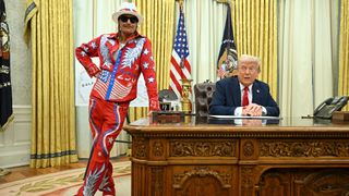 US President Donald Trump signs an executive order alongside US singer Kid Rock in the Oval Office of the White House in Washington, DC, on March 31, 2025. 