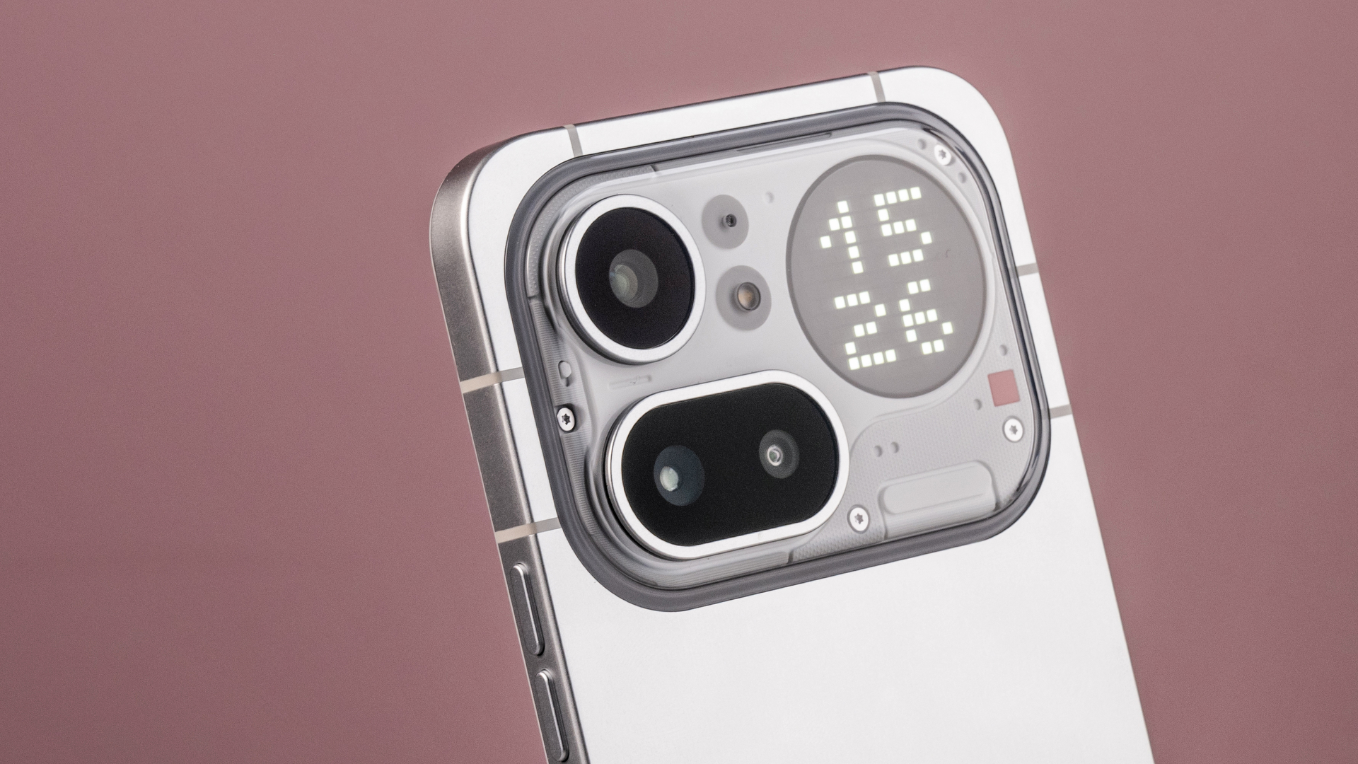 A closeup of the Nothing Phone (4a) Pro's camera module and Glyph Matrix, which features a digital clock reading '15:26'.