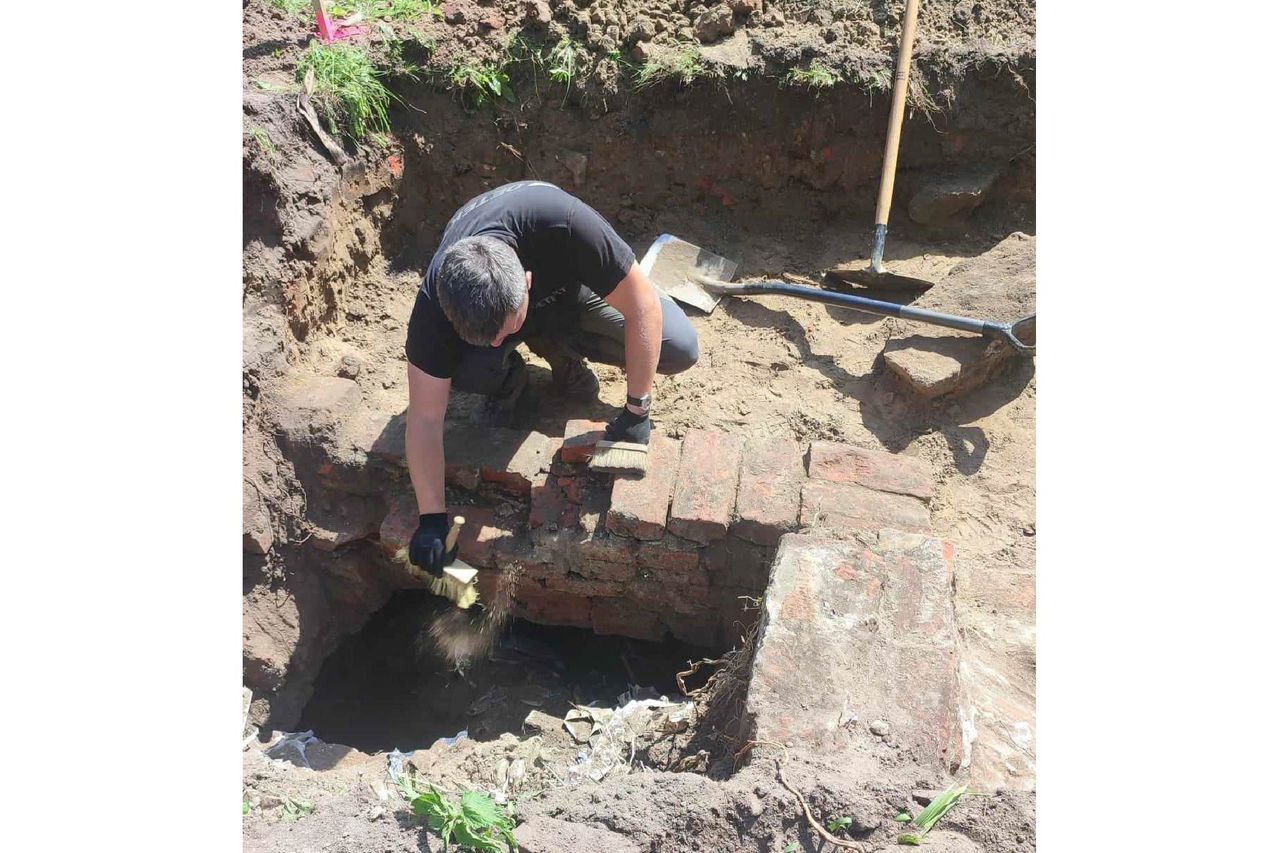 A man excavates from a pit