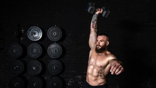 Man performs dumbbell snatch
