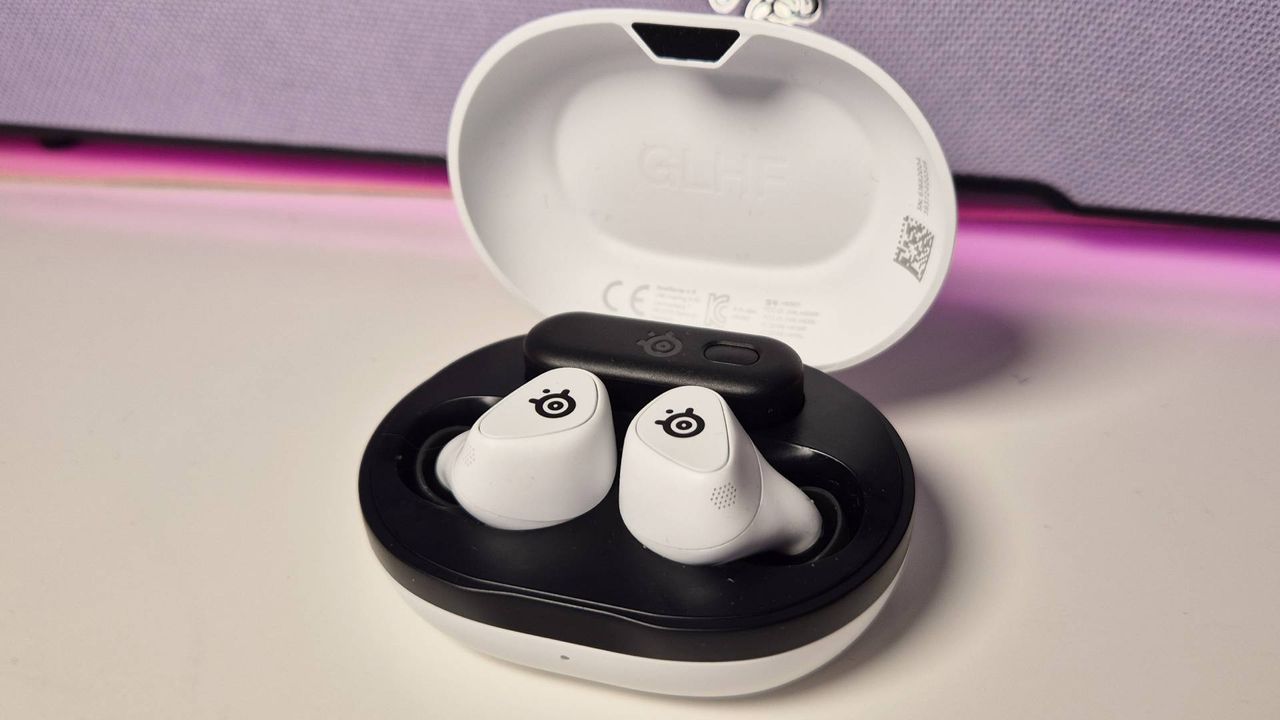Photo of the SteelSeries Arctis Game Buds on a white desk.