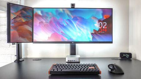 A picture of a desk setup with a portable monitor mounted next to an ultrawide