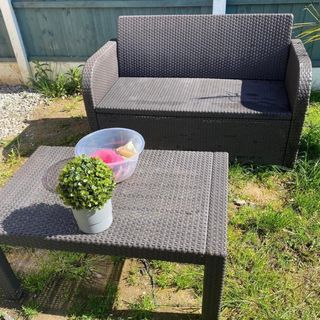 Old rattan grey garden furniture with coffee table and chair
