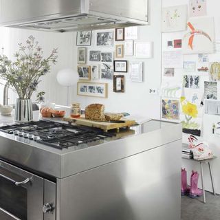 kitchen with gas cooktop white walls and kitchen hood with bread