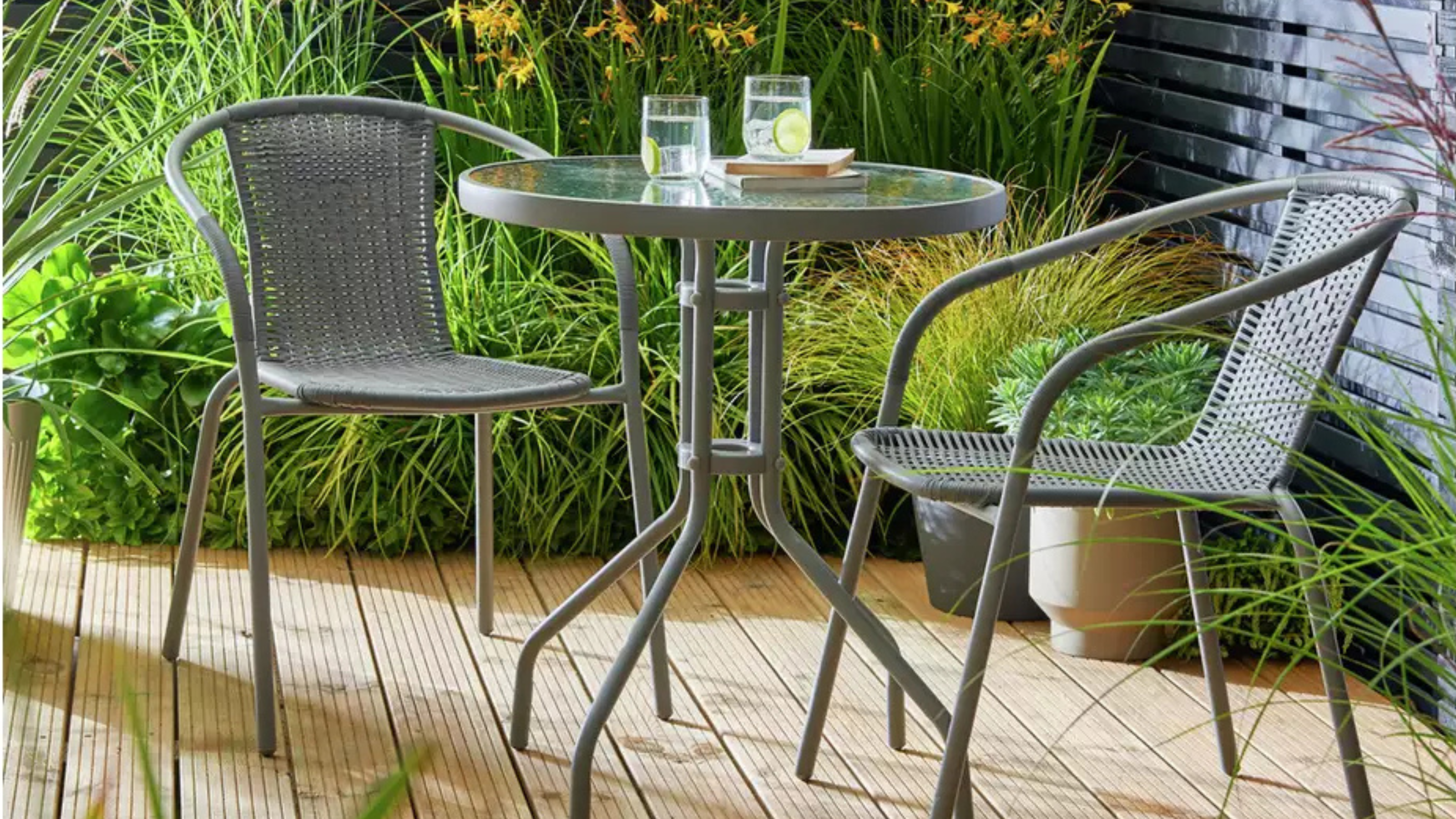 Argos Home 2 Seater Rattan Effect Garden Bistro Set in grey on garden decking.