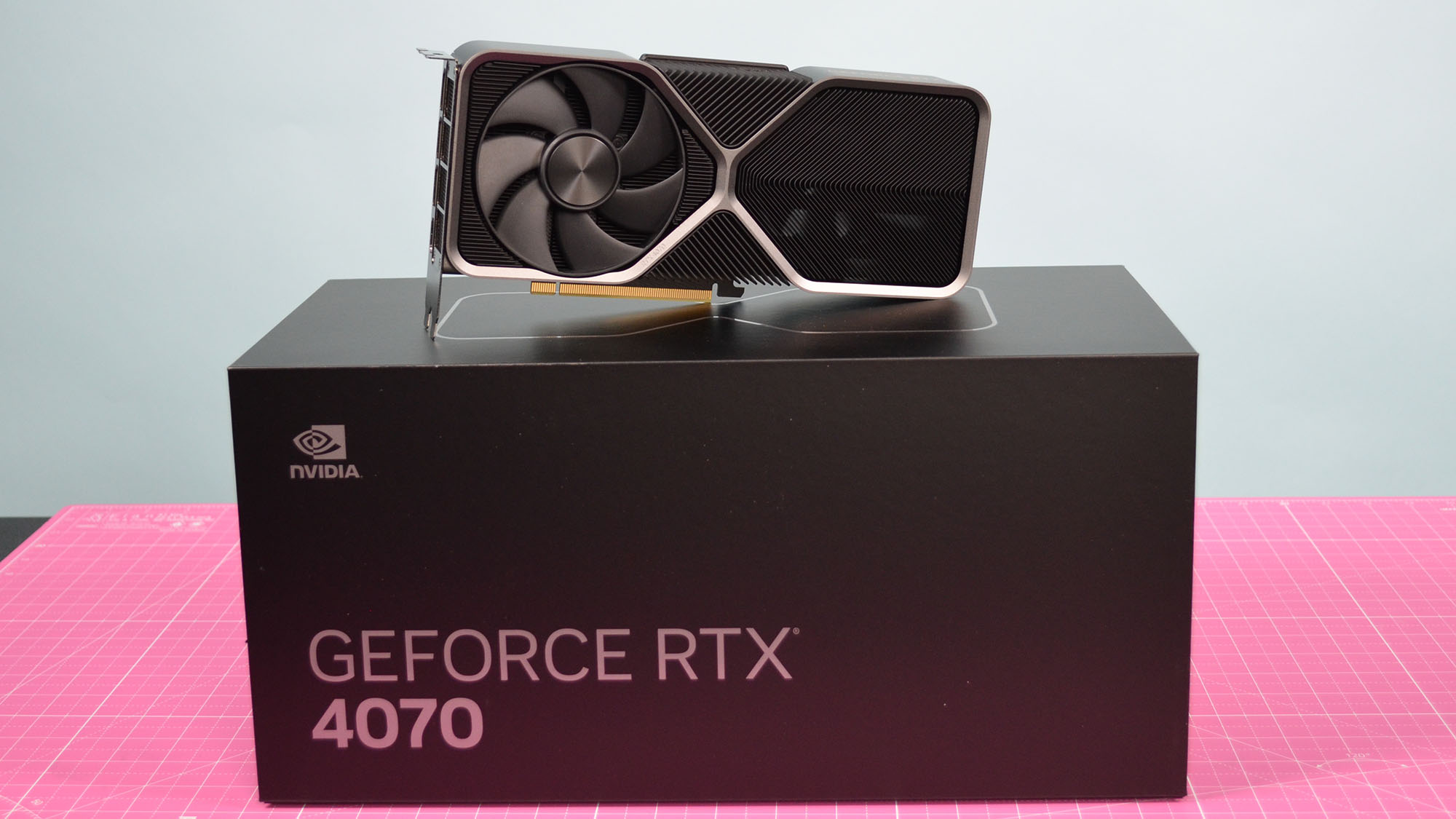 The Nvidia GeForce RTX 4070 graphics card standing on top of its retail packaging