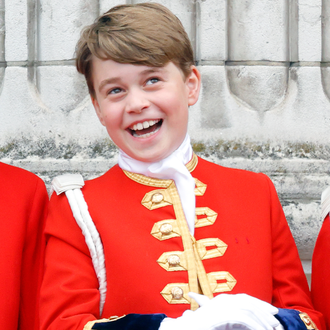 Prince George wearing a red uniform laughing