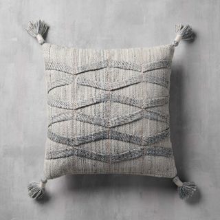 Grey pillow with tassel embellishments 