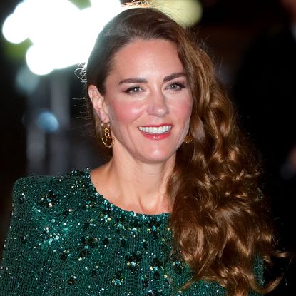 Kate Middleton has long curly brown hair and wears a green sequin gown for the Royal Variety Performance at London's Royal Albert Hall on November 18, 2021