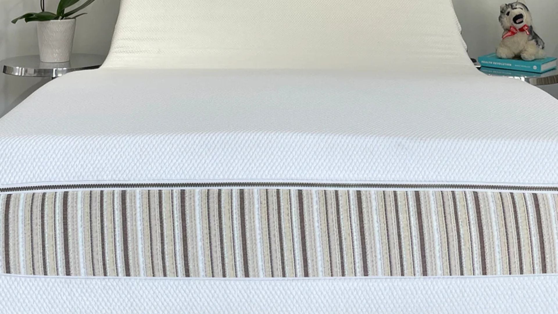 A close up of the foot of the Essentia Venti mattress with its striped cover