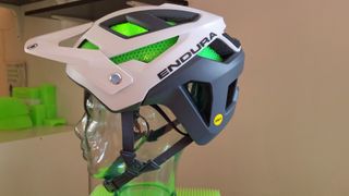 A side view of the new Endura MT500 MIPS helmet in white and grey with green Koroyd