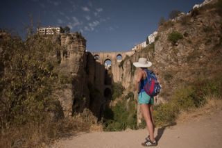 A tourist looks at the Puente Nuevo (New Bridge) in Ronda on August 28, 2014.AFP PHOTO / JORGE GUERRERO(Photo credit should read Jorge Guerrero/AFP/Getty Images)