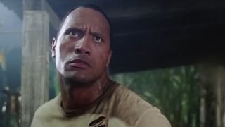 Dwayne Johnson stands up to battle in a jungle in The Rundown