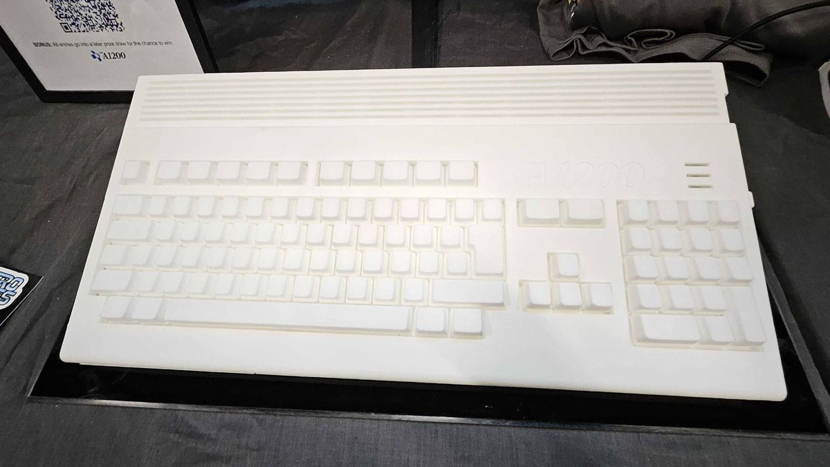 Top down view of White Amiga A1200 prototype on black table at Gamescom 2025.