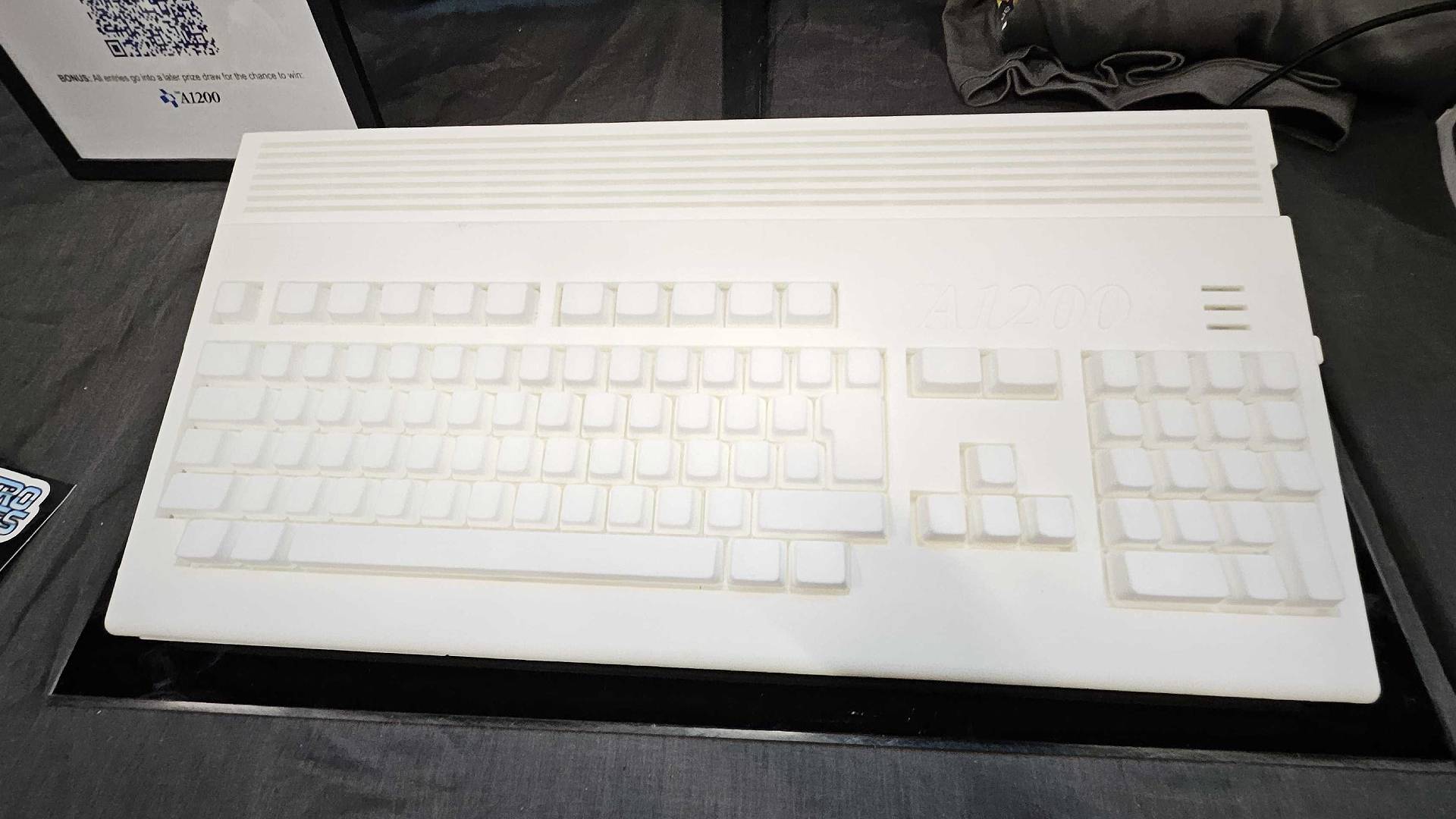 Top down view of White Amiga A1200 prototype on black table at Gamescom 2025.