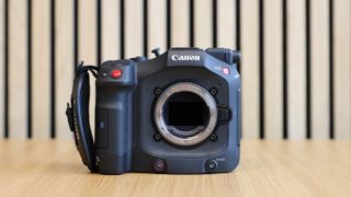 Canon EOS C80 cinema camera on wooden desk with wooden paneling behind