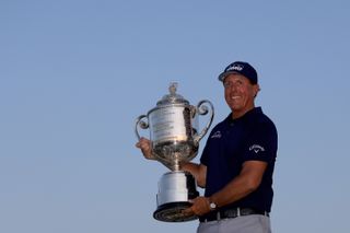 Mickelson holds a trophy