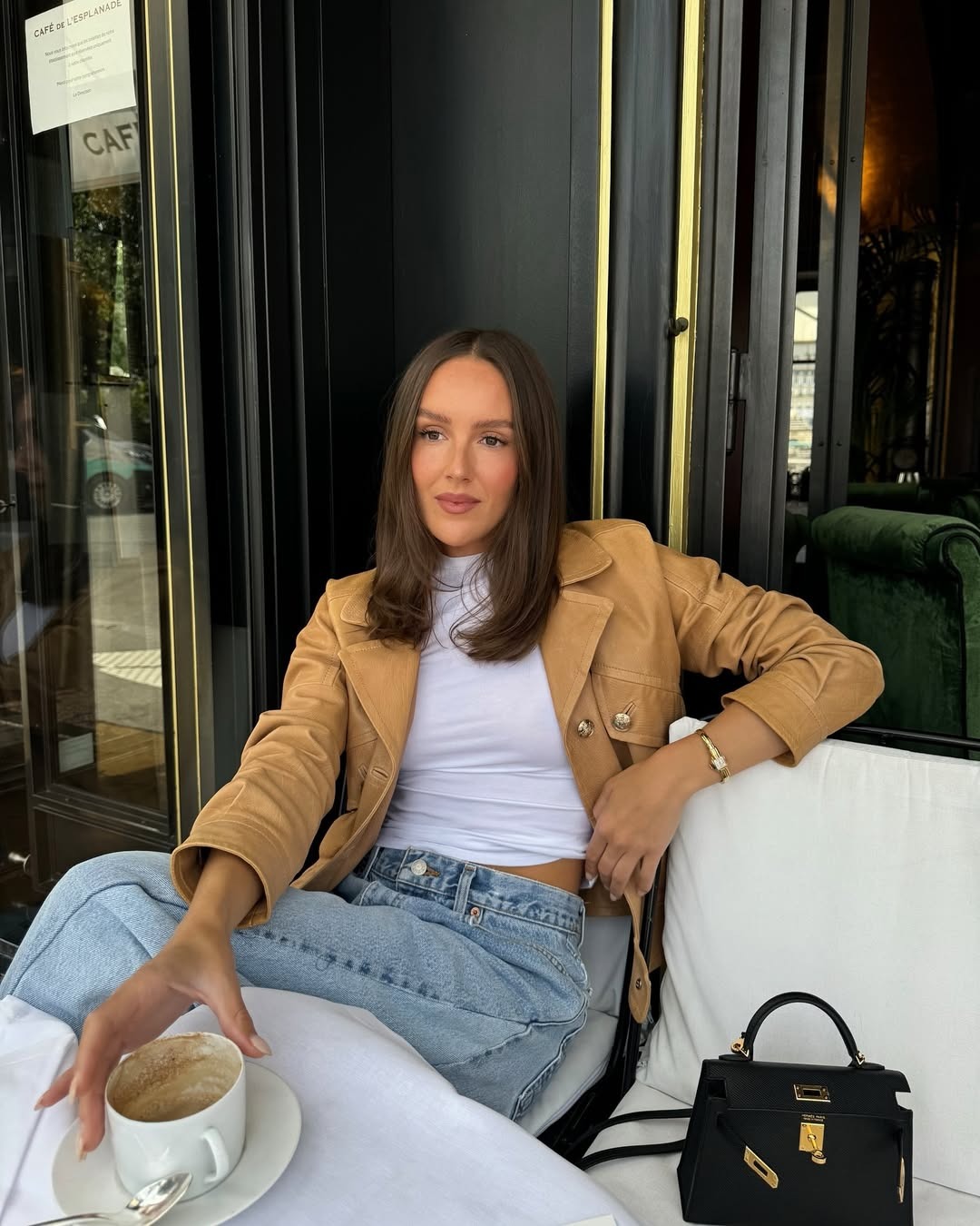 Emma Leger wears a leather jacket with a white shirt