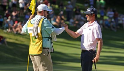 Poston shakes hands with his caddie as he celebrates his win at the John Deere Classic