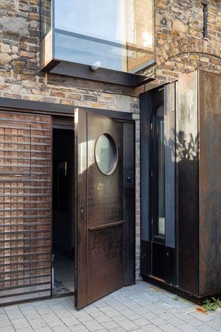 The annex’s garage door, with an oculus that mirrors the coach house’s original circular windows