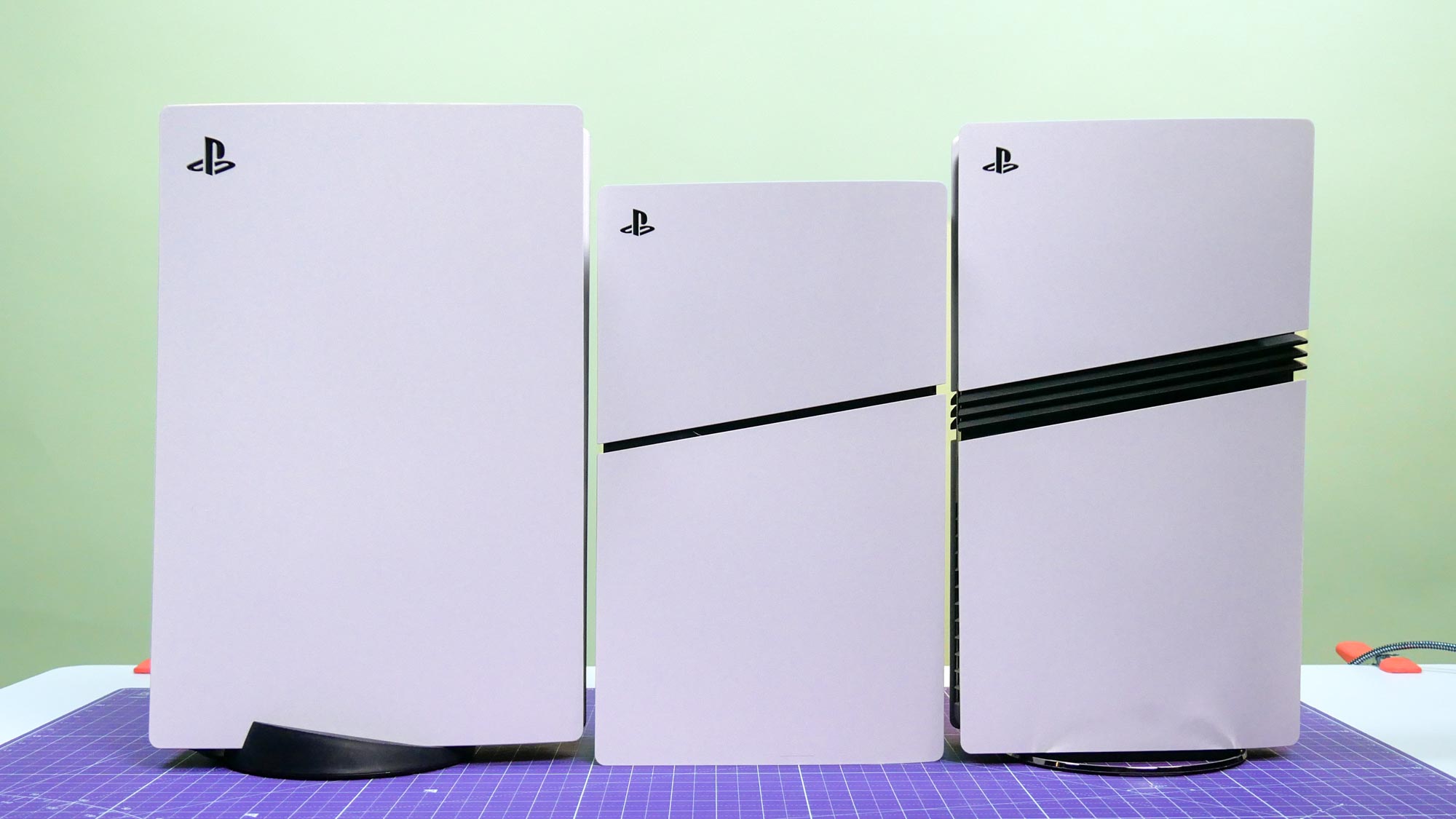 (L-R) PS5, PS5 Slim and PS5 Pro together on a table