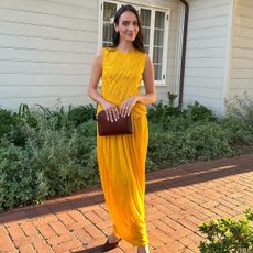 Influencer Liv Perez wearing a yellow wedding guest dress