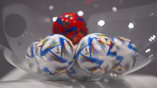 Balls for the teams in the Qatar 2022 World Cup draw in a bowl