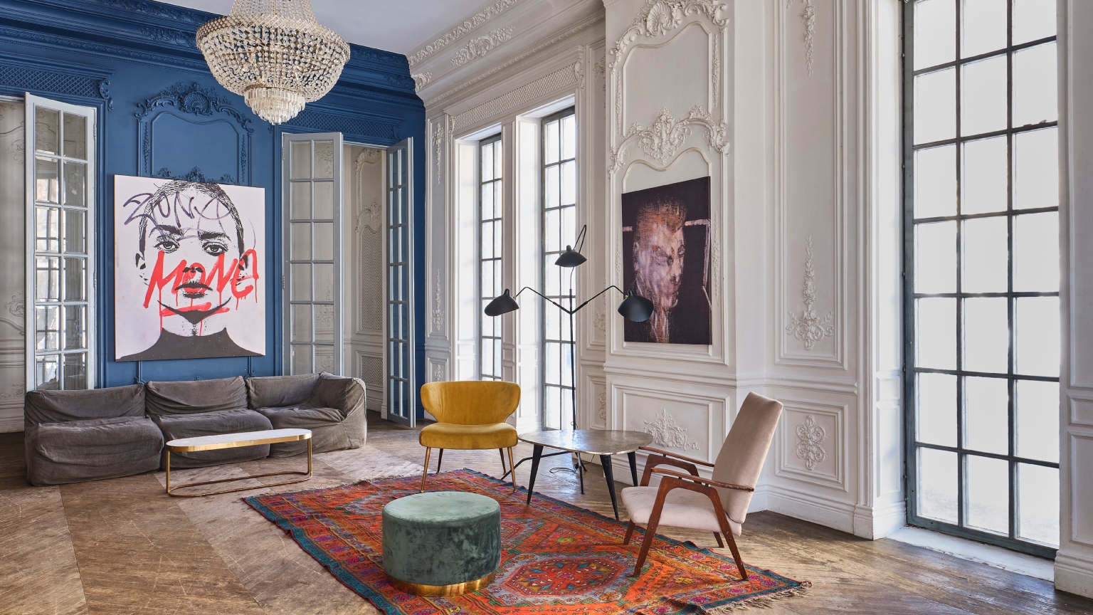 interior of a mansion with chic furniture, big windows, and wood floors