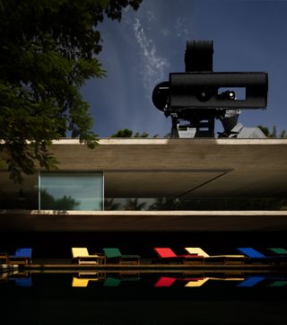 casa paraty by marcio kogan with an image of a man with a camera collaged above it from Jean-Luc Godard's Le Mepris