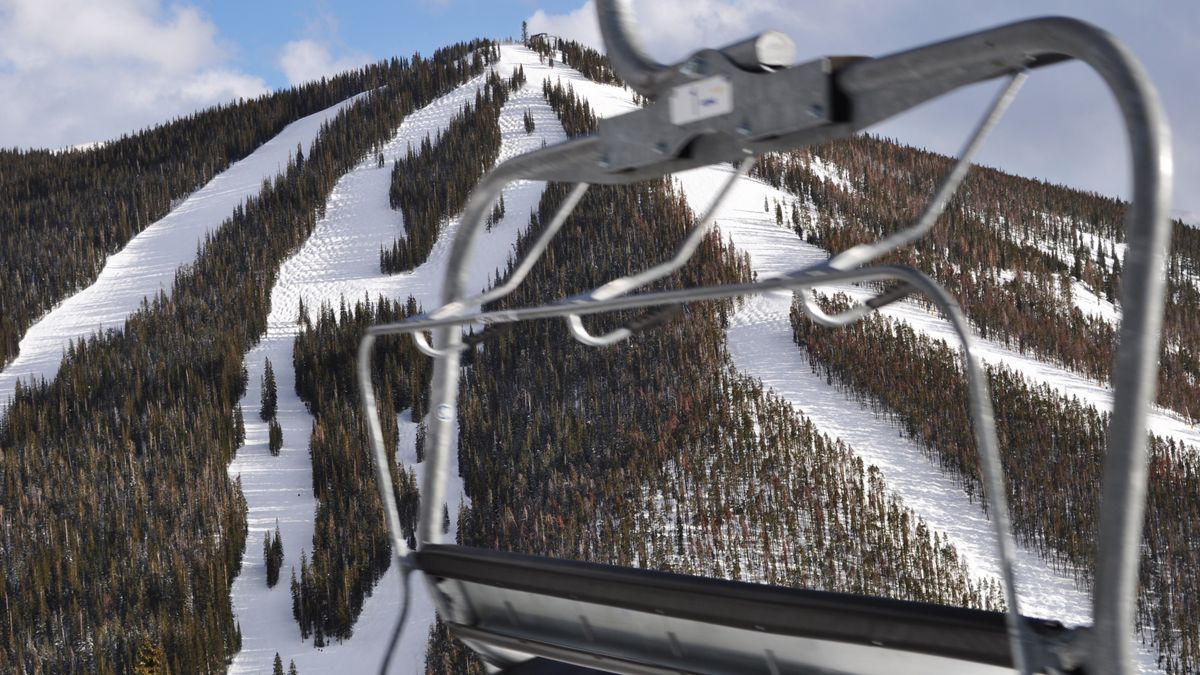 Chair lift moving past the ski slopes at Keystone, Colorado in the Rocky Mountains.