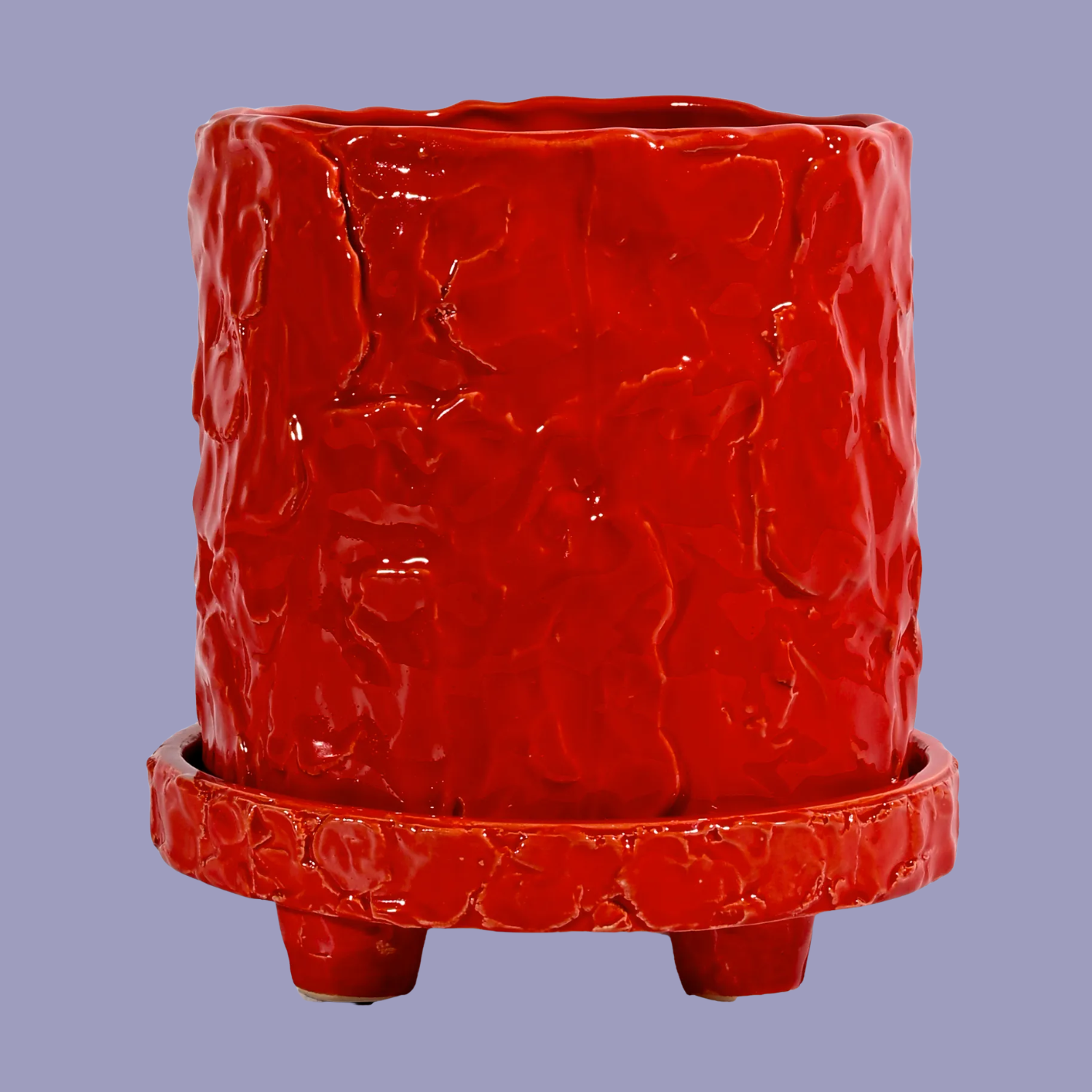A textured red planter with a stand
