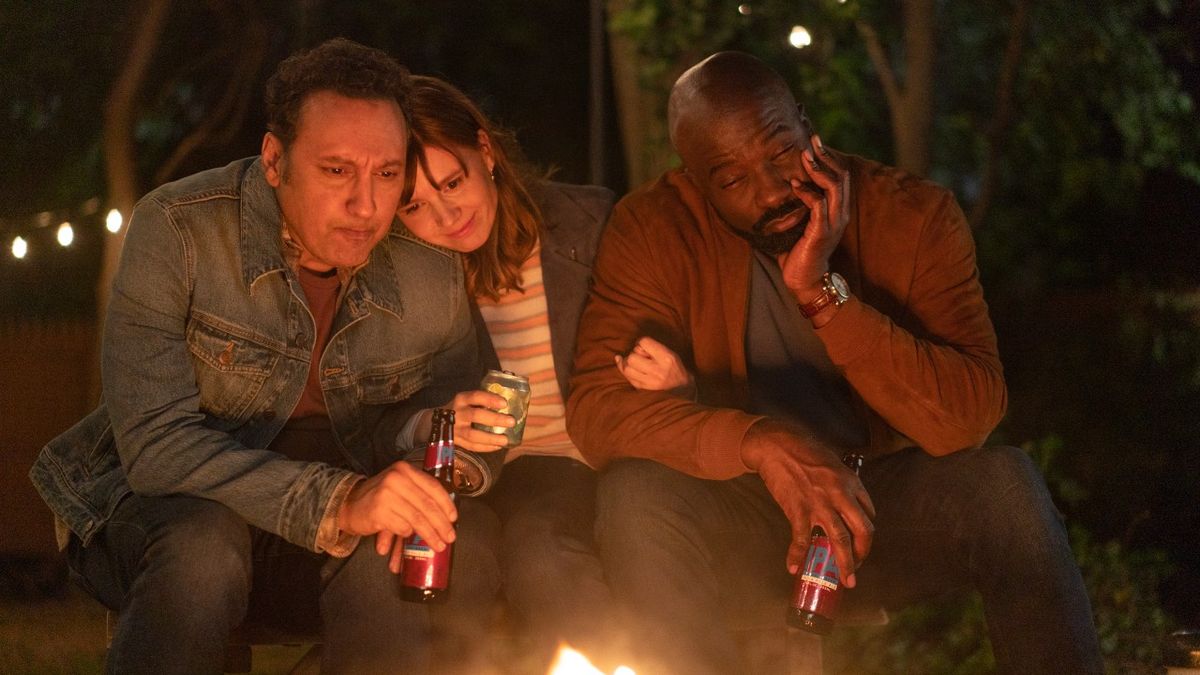 L-R Aasif Mandvi as Ben Shakir, Katja Herbers as Kristen Bouchard and Mike Colter as David Acosta sitting around a fire in Season 4, episode 14 of Evil.