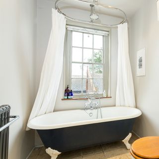 bathroom with bathtub and sash window