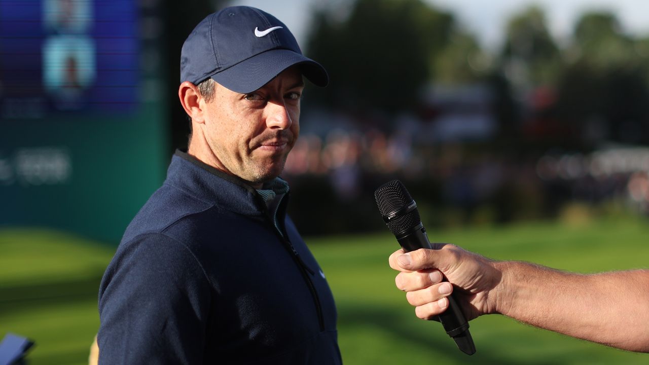 Rory McIlroy focusing on his golf swing with intense concentration